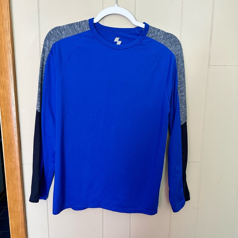 Blue long sleeve shirt. Gray and black patches on sleeves.